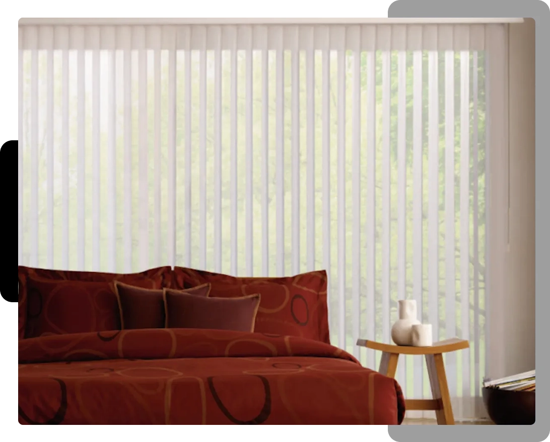 A bedroom with red and white bedding, a table and a window.