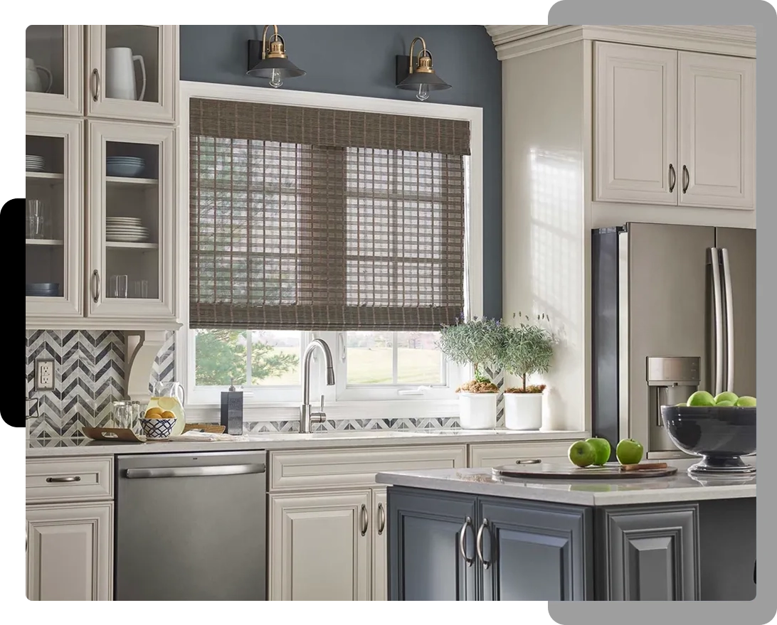 A kitchen with white cabinets and black window blinds.