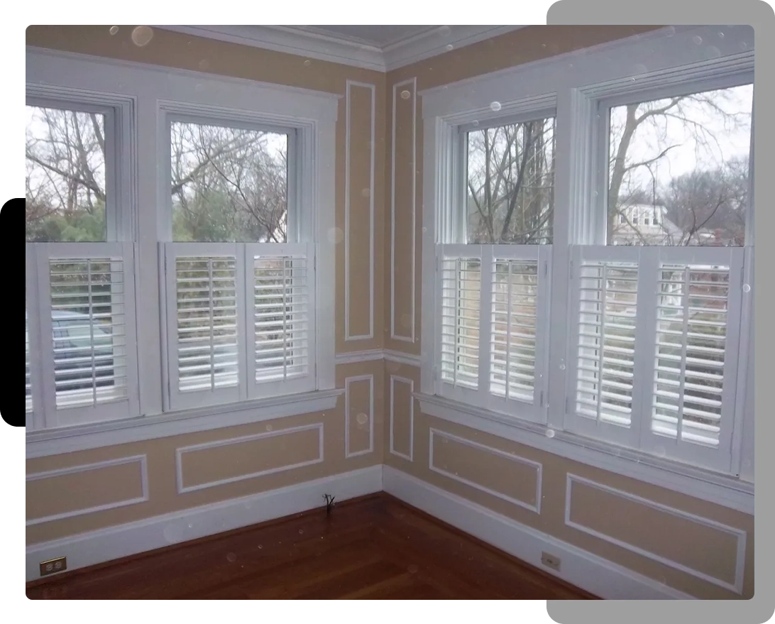 A room with two windows and a wooden floor