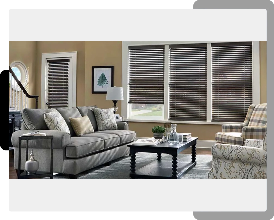 A living room with gray furniture and brown walls.