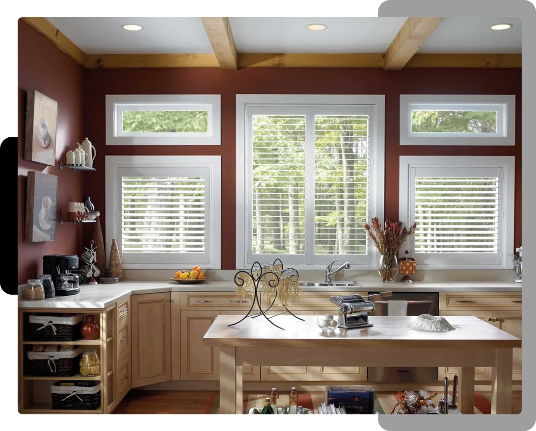 A kitchen with a large window and wooden cabinets