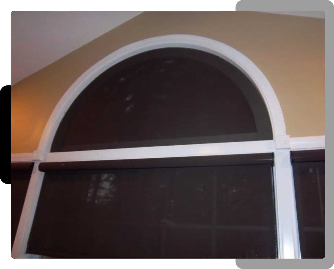 A window with dark brown fabric and white trim.