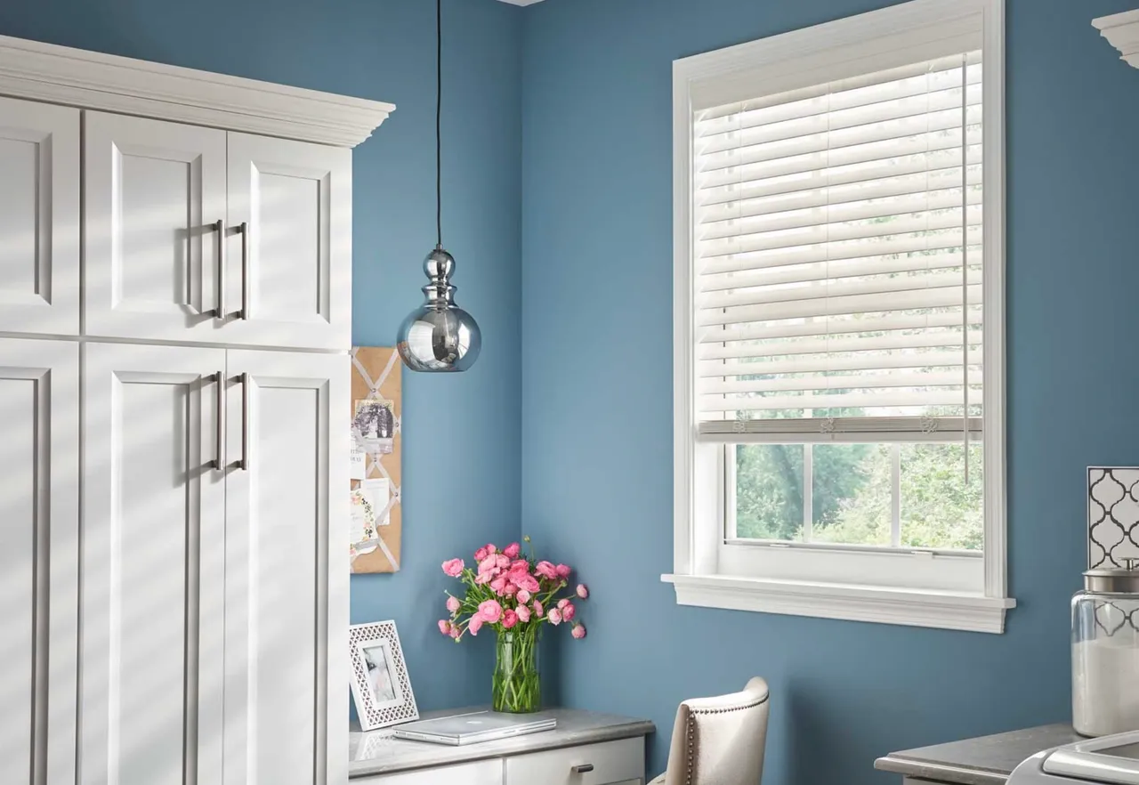 A room with blue walls and white furniture.